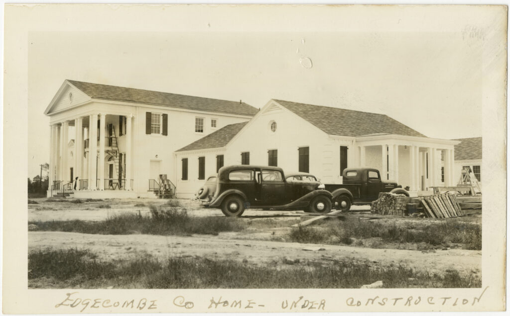 The Edgecombe County Home under construction, with vintage cars parked in front, circa 1937
